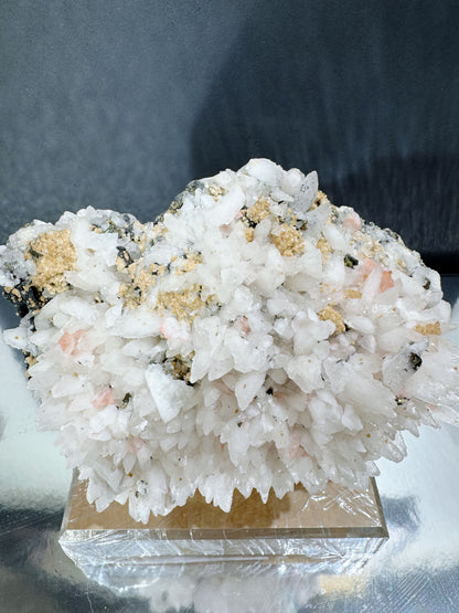 snowy white calcite cluster with wolframite