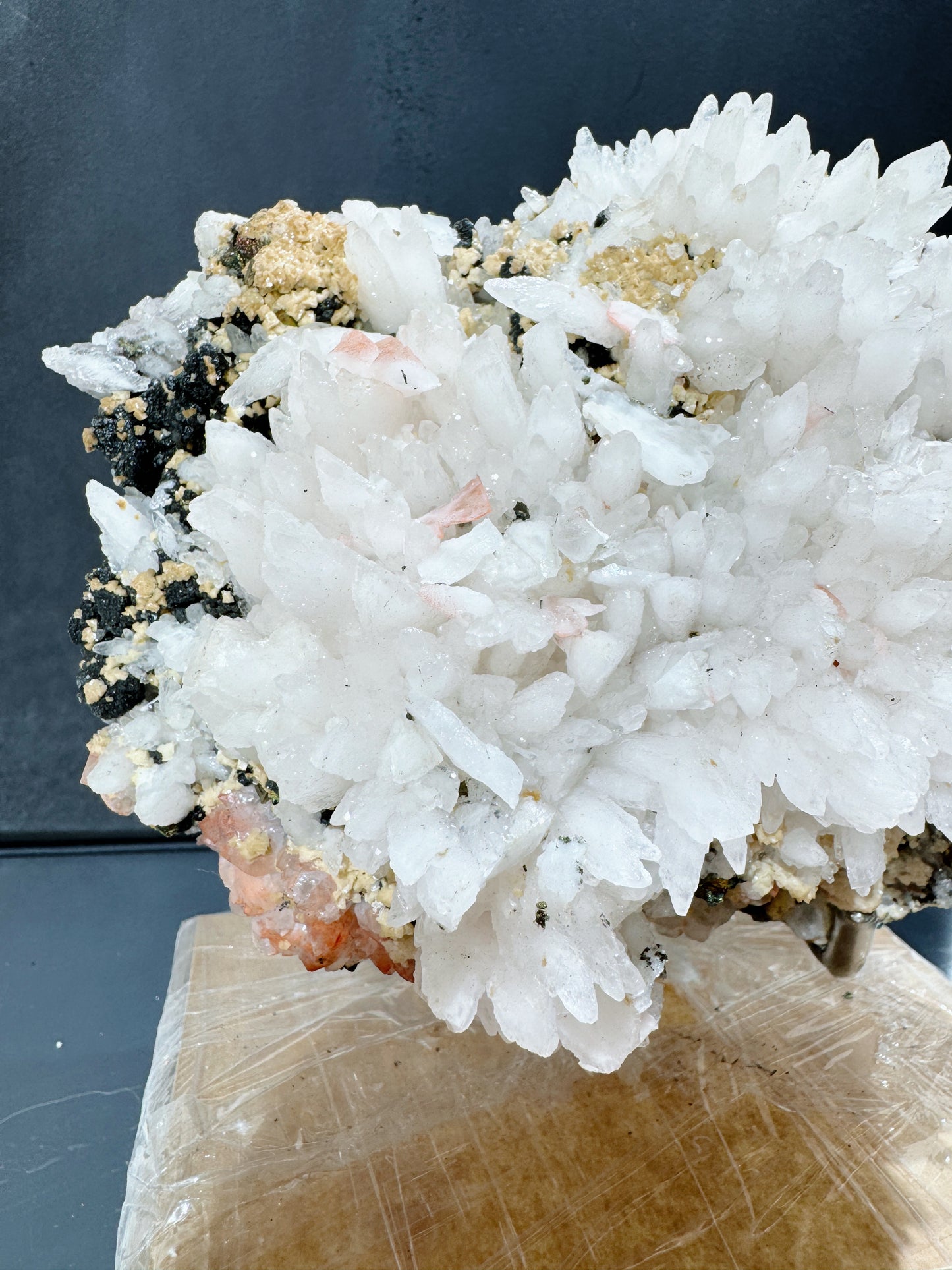 snowy white calcite cluster with wolframite