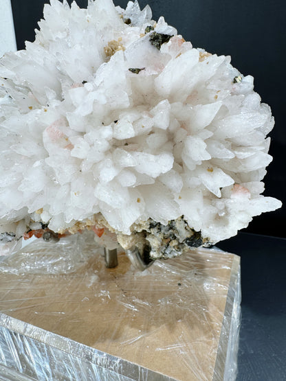 snowy white calcite cluster with wolframite