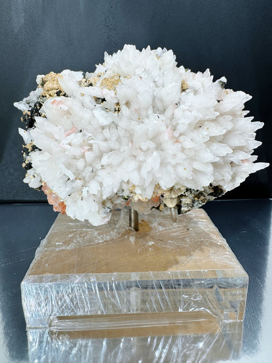 snowy white calcite cluster with wolframite